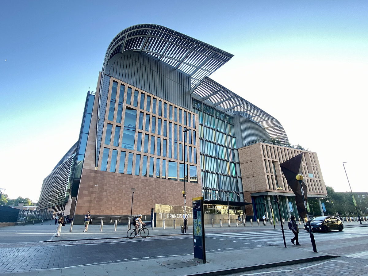The Francis Crick Institute building on Euston Road, London, seen from the pavement with its curved roof and glazed frontage